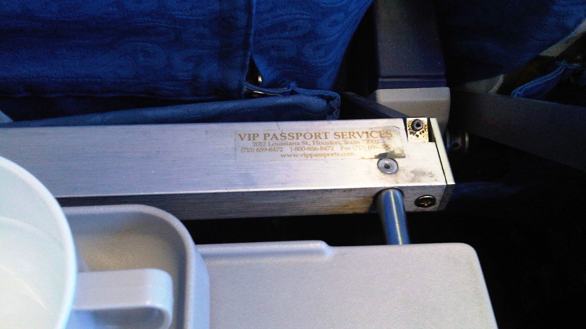 Passport Services sticker on airplane seat
